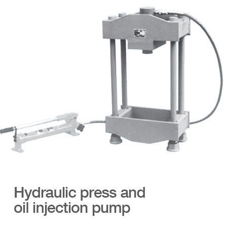 Hydraulic Press and Oil Injection Pump A hydraulic press attached to an oil injection pump.